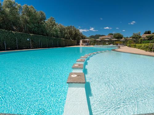 a large swimming pool with blue water at Ville D'Ogliastra in Cardedu