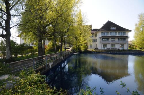 a house with a pond in front of it at Kloster Kappel in Kappel am Albis