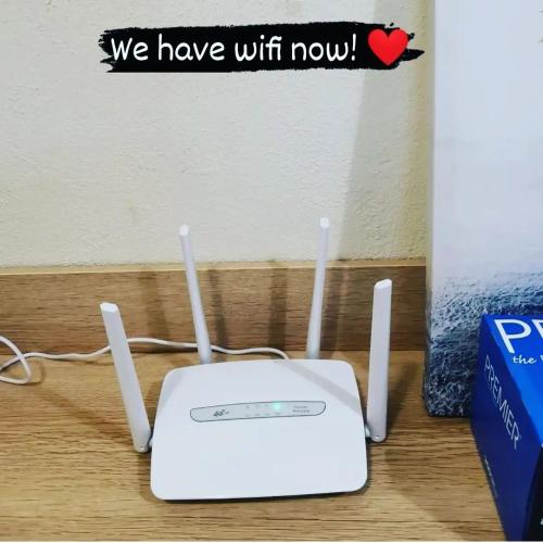a white router sitting on top of a table at HomestayKu @Bachok in Bachok