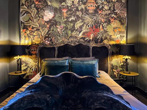 a bedroom with a bed with a tapestry on the wall at Alice in Spa
