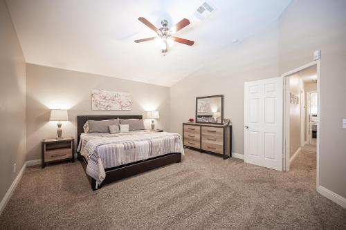a bedroom with a bed and a ceiling fan at Brilliant 4 Bedroom House With Pool! in Las Vegas