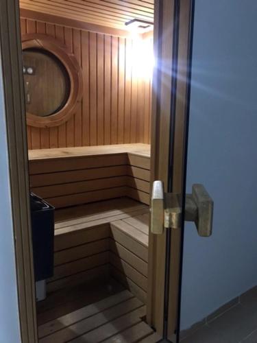 a small room with a sauna with a mirror at RZA HOTEL in Aşağı İmrahor