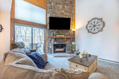 a living room with a couch and a fireplace at Luxury Seven Springs Condo- 3 Bed & Loft, 3 Bath in Champion