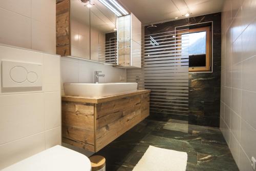 a bathroom with a sink and a toilet at Haus Klaffenböck in Bad Gastein