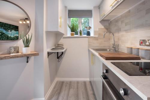 a kitchen with a sink and a mirror at Eden's Peaceful Escape Apartment in Kendal