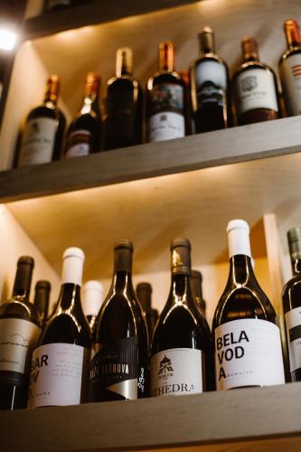 a bunch of bottles of wine sitting on shelves at Rtanj Kopaonik Eco Resort & Spa in Kopaonik