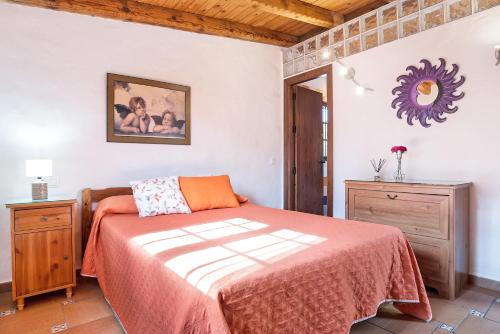 a bedroom with a bed with an orange blanket at Villa Giovanni in Barbate