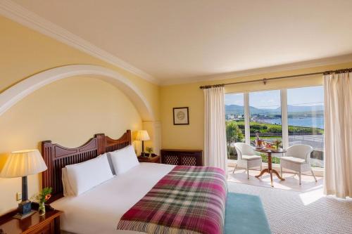 a bedroom with a bed and a balcony with a table at Butler Arms Hotel in Waterville
