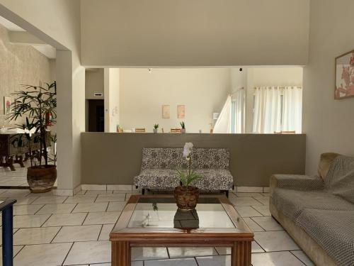 a living room with a couch and a coffee table at Ouro Hotel in Ourinhos