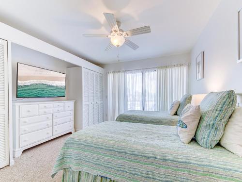 a bedroom with two beds and a ceiling fan at Sea Matanzas 2 in Saint Augustine