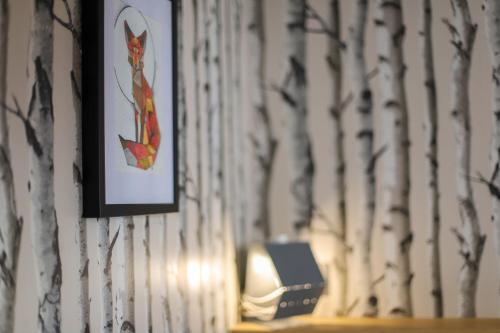 a wall with a picture of a squirrel on a wall at L'Eau Vive Jacuzzi et Sauna en vieille ville 5 in Annecy