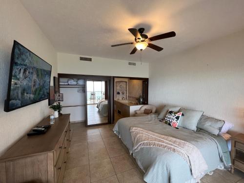 a bedroom with a bed and a ceiling fan at Sonoran Sky in Puerto Peñasco