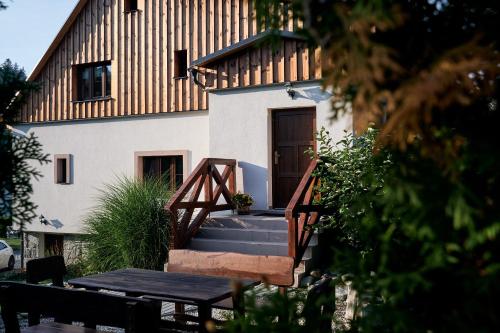 a house with a staircase leading up to a building at Apartmány Pod Stráni in Malá Morávka