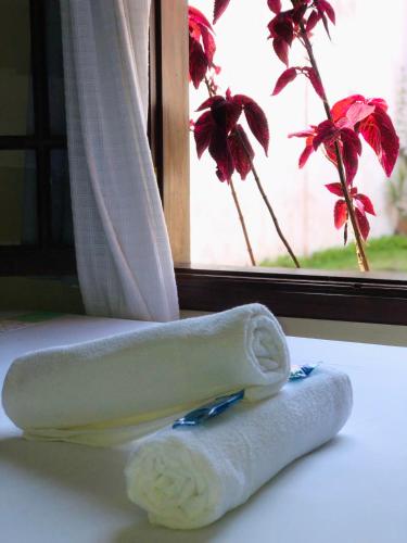 a towel and a toothbrush sitting next to a window at Pousada Brisa de Paraty in Paraty