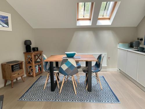 a kitchen with a wooden table and chairs at River Vista Retreat - Luxury duplex Apt - Views - Parking - Cycle storage - Spa access option in Backbarrow