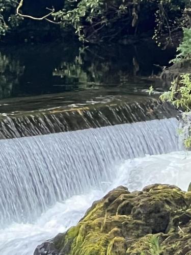 a waterfall in the middle of a river at River Vista Retreat - Luxury duplex Apt - Views - Parking - Cycle storage - Spa access option in Backbarrow