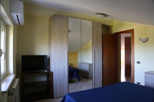 a bedroom with a blue bed and a mirror at La Masseria PietraMarmo Caiazzo - App to con vista in Caiazzo