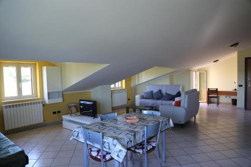 a living room with a table and a couch at La Masseria PietraMarmo Caiazzo - App to con vista in Caiazzo