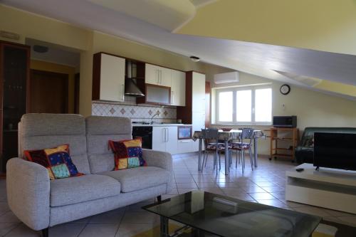 a living room with a couch and a table at La Masseria PietraMarmo Caiazzo - App to con vista in Caiazzo