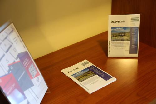 a table with a brochure and a box on it at La Masseria PietraMarmo Caiazzo - App to con vista in Caiazzo