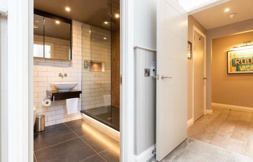 a bathroom with a sink and a toilet in it at The Lawrance Luxury Aparthotel - York in York