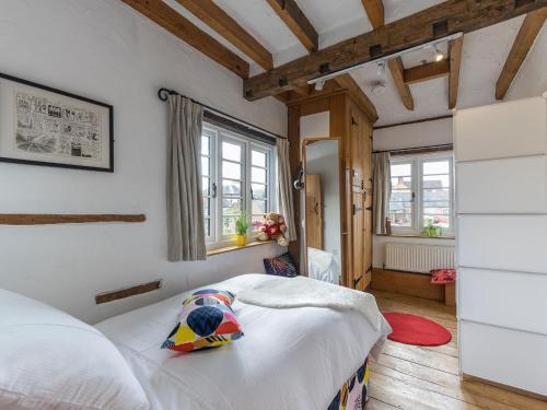 a bedroom with a white bed in a room with windows at The Old Rope Works in Bewdley