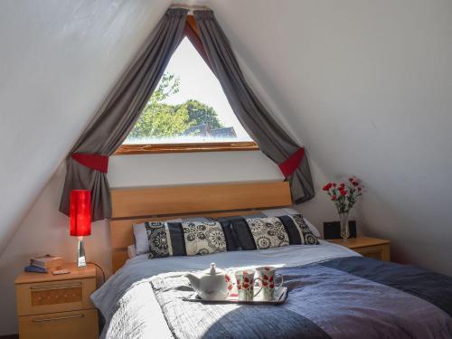 a bedroom with a bed with a large window at Poppy Lodge in Kingsdown
