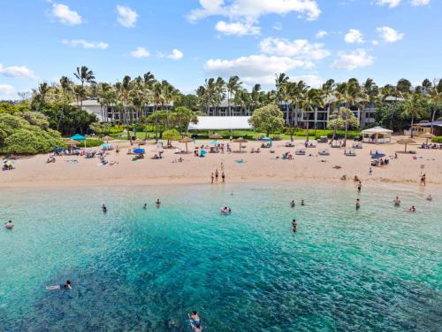 a group of people in the water at a beach at Turtle Bay Villas 205 in Kahuku