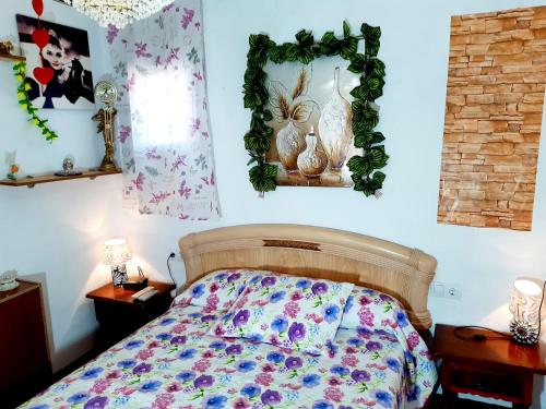 a bedroom with a bed with flowers on it at 4 bedrooms house with city view balcony and wifi at Illar in Illar