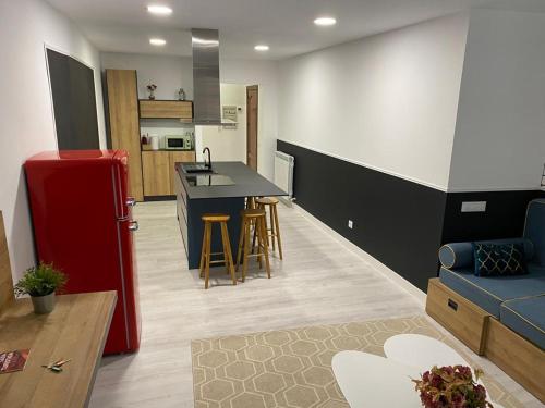 a kitchen and a living room with a red refrigerator at Apartamento Concarera in Tudela