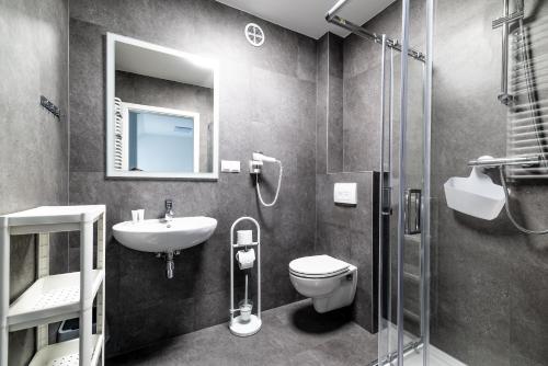 a bathroom with a sink and a toilet and a shower at EXPO HOSTEL in Kielce