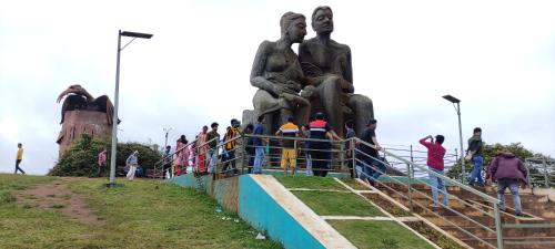 a group of people standing in front of a statue at Shawn Dale Homestay in Ramakkalmedu