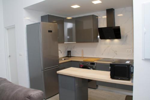 a kitchen with a refrigerator and a counter top at Nuevo Apartamento Sevilla centro, Trastamara 25 in Seville