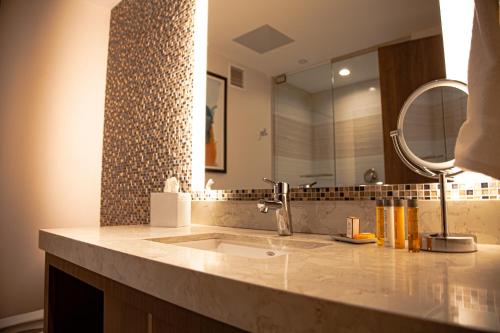 a bathroom with a sink and a mirror at The Landing Hotel at Rivers Casino Pittsburgh in Pittsburgh