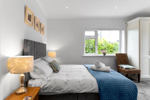 a bedroom with a bed and a table and a window at Private Room with Private Entrance. in Galway
