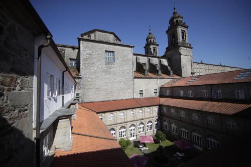 an aerial view of a building with a clock tower at San Francisco Hotel Monumento in Santiago de Compostela