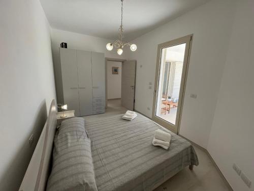 a bedroom with a bed and a large mirror at QUASI NELL'ACQUA in Torre Pali 