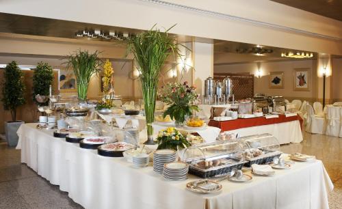 a buffet table with food on it in a restaurant at Astoria Palace Hotel in Palermo