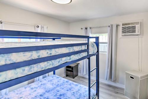 a bedroom with two bunk beds and a window at Key Largo Home with Dock and Private Beach Access in Key Largo
