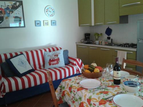 a living room with a table and a couch at Casa Luciana in Mergozzo