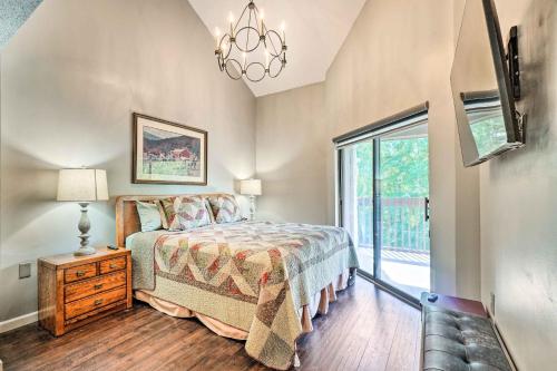 a bedroom with a bed and a large window at Cozy Gatlinburg Condo about 2 Mi to National Park! in Gatlinburg