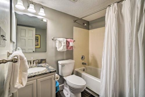 a bathroom with a toilet and a sink and a tub at Cozy Gatlinburg Condo about 2 Mi to National Park! in Gatlinburg
