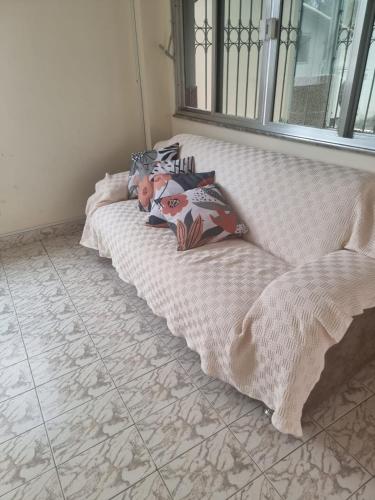 a baby laying on a bed in a room at Pousada Regina in Cachoeiro de Itapemirim