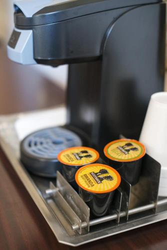 three cupcakes are sitting on top of a coffee maker at Arlington Resort Hotel & Spa in Hot Springs