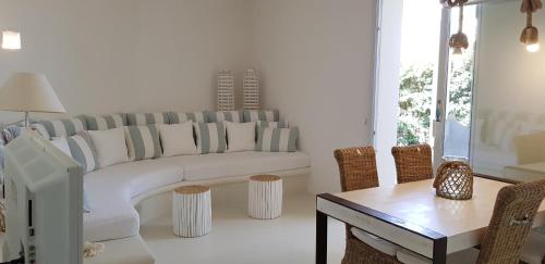 a living room with a white couch and a table at Casa Mirella in Favignana