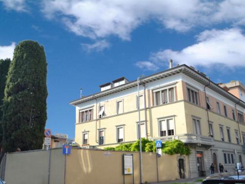 a large white building with a fence in front of it at Dany Sweethouse in Bergamo