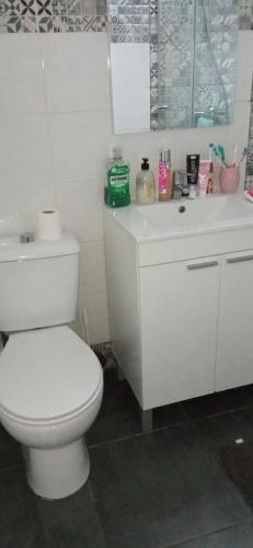 a bathroom with a white toilet and a sink at Las súper noches in Castellón de la Plana
