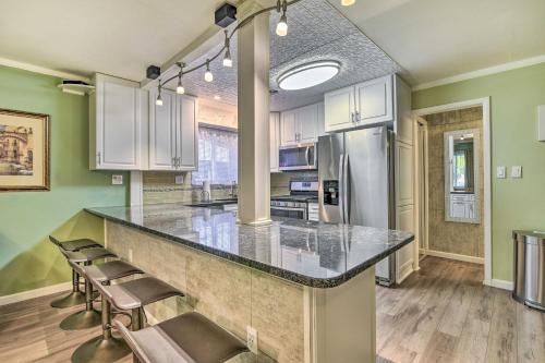 a kitchen with a counter with chairs and a refrigerator at Pet-Friendly Taylor Home with Backyard Oasis! in Taylor
