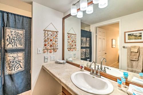 a bathroom with a sink and a mirror at Kaunakakai Escape Heated Pool and Beach Access in Kaunakakai