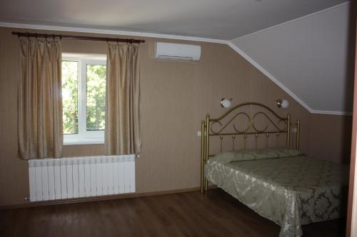 a bedroom with a bed and a window at Hotel Gostynnyi Dvir in Bucha